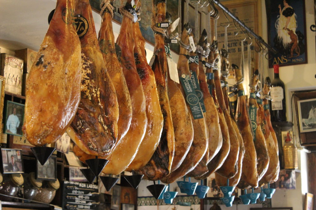 Legs of Spanish ham hanging from the ceiling of a Seville bar.