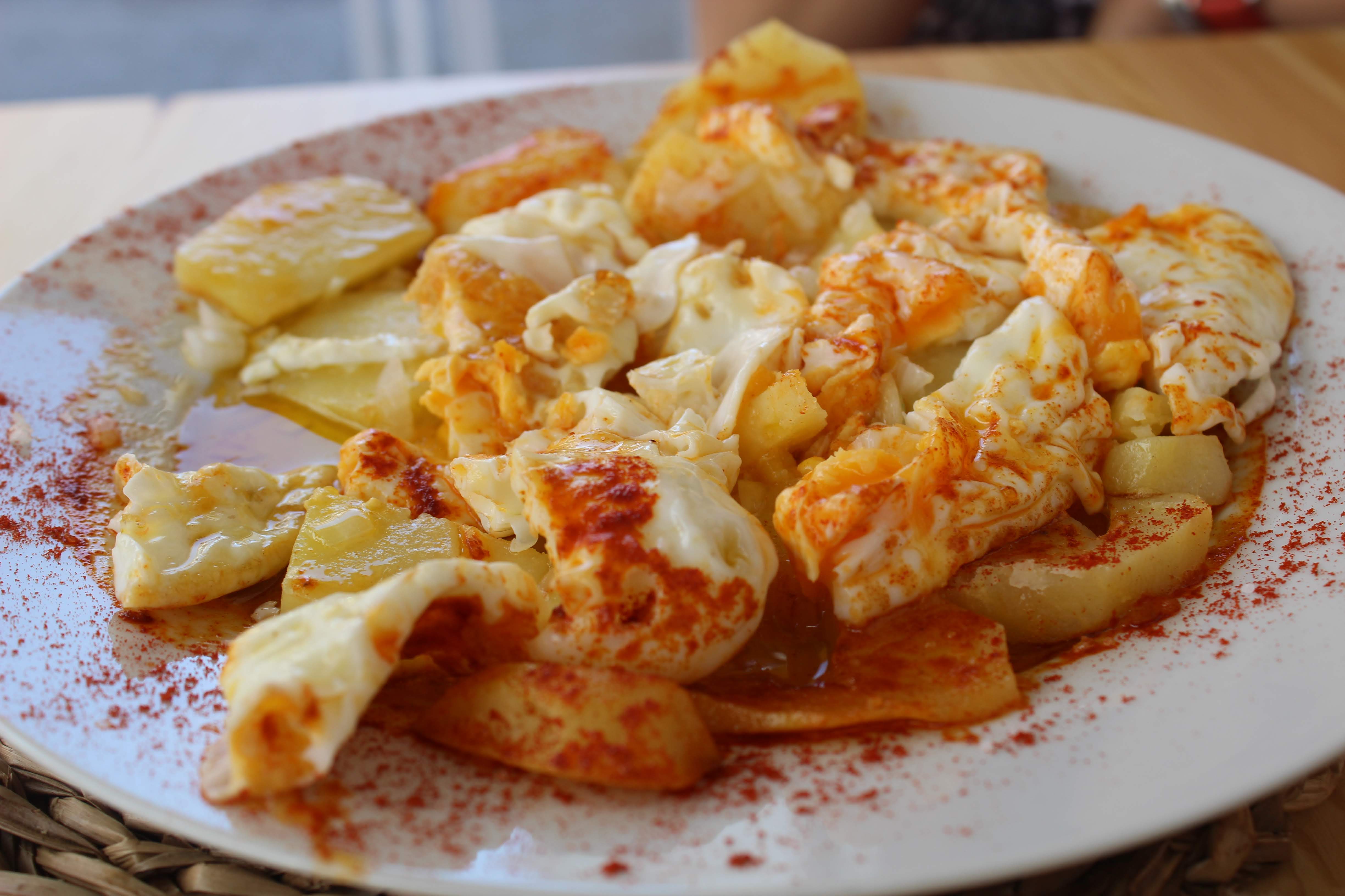 Spanish eggs, garnished with paprika.