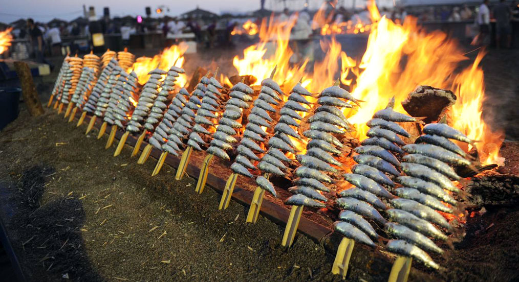 sardines at a barbecue on a Malaga beach.